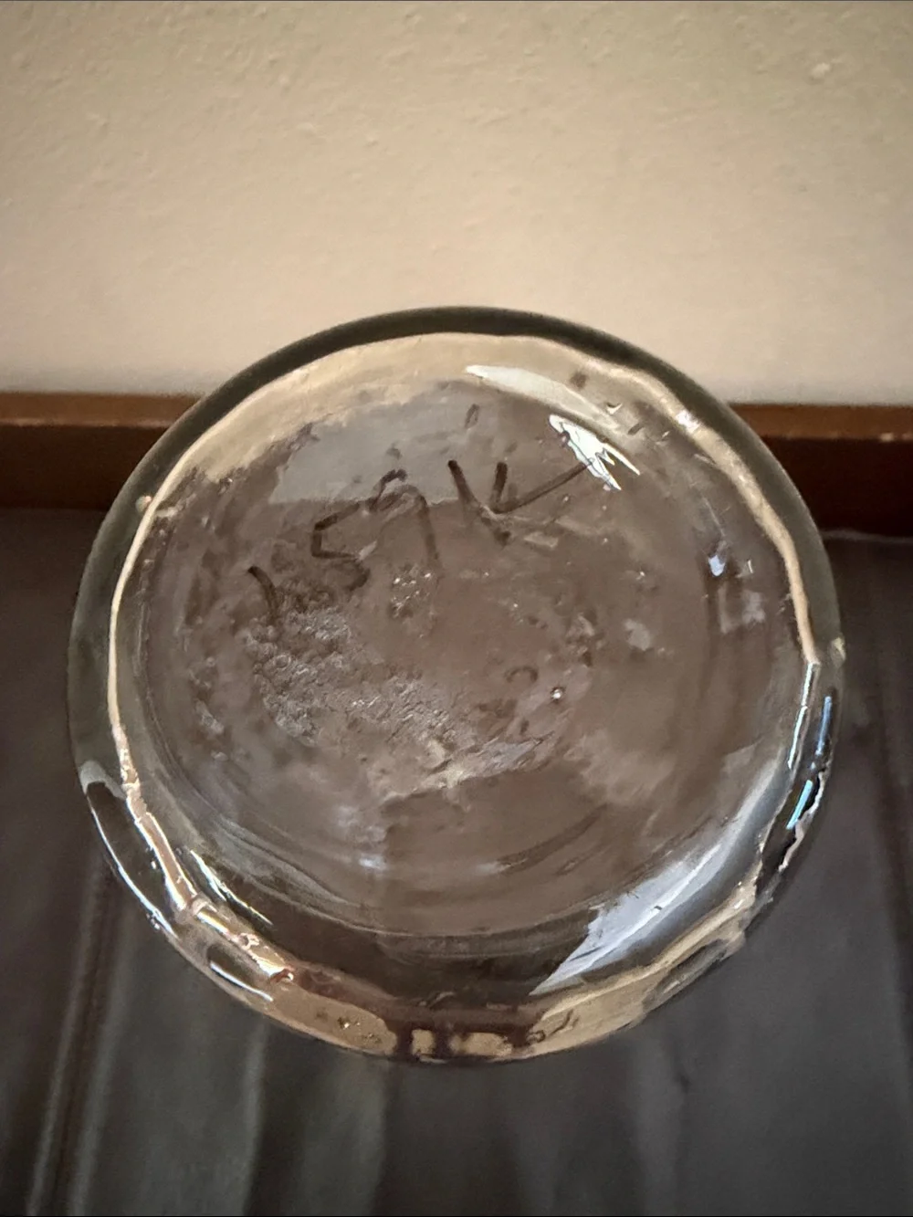Clear Glass Vase Features Scalloped Rim Opening Tapering Down to a Narrow Base